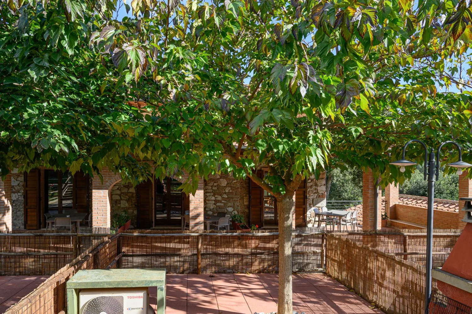 The fenced, tiled outdoor spaces in front of the porticoes